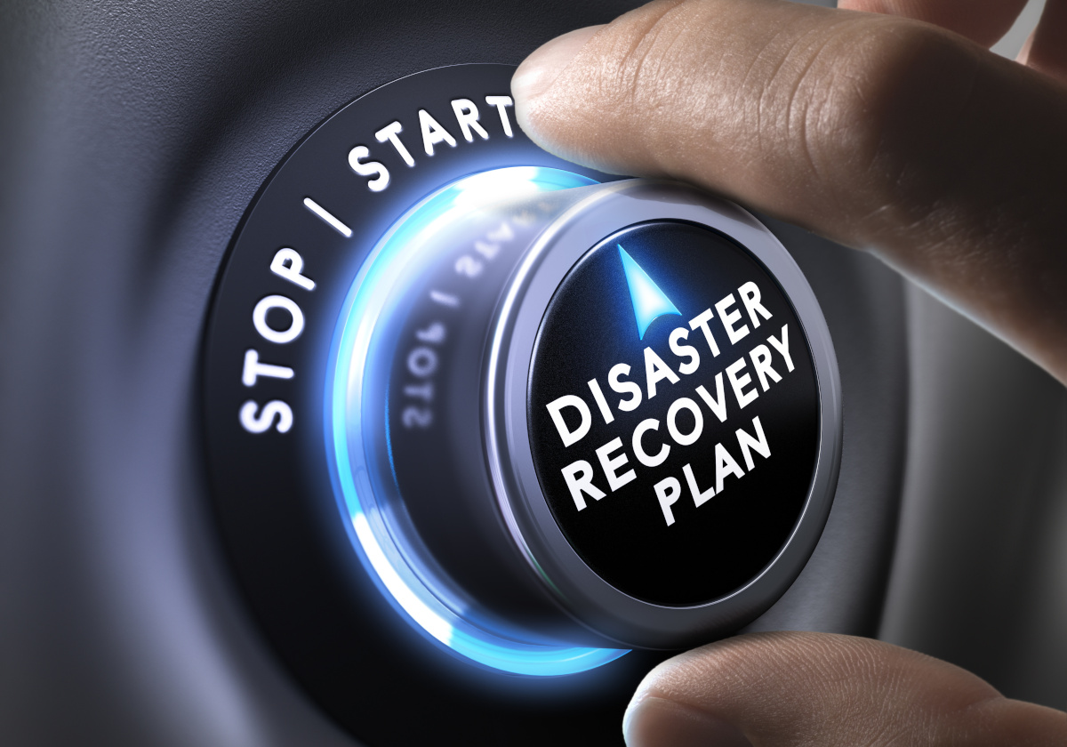 Man turning button with disaster recovery words on it